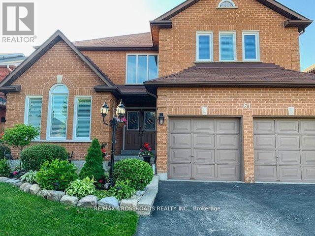 A house with a brown brick exterior and a garage door.