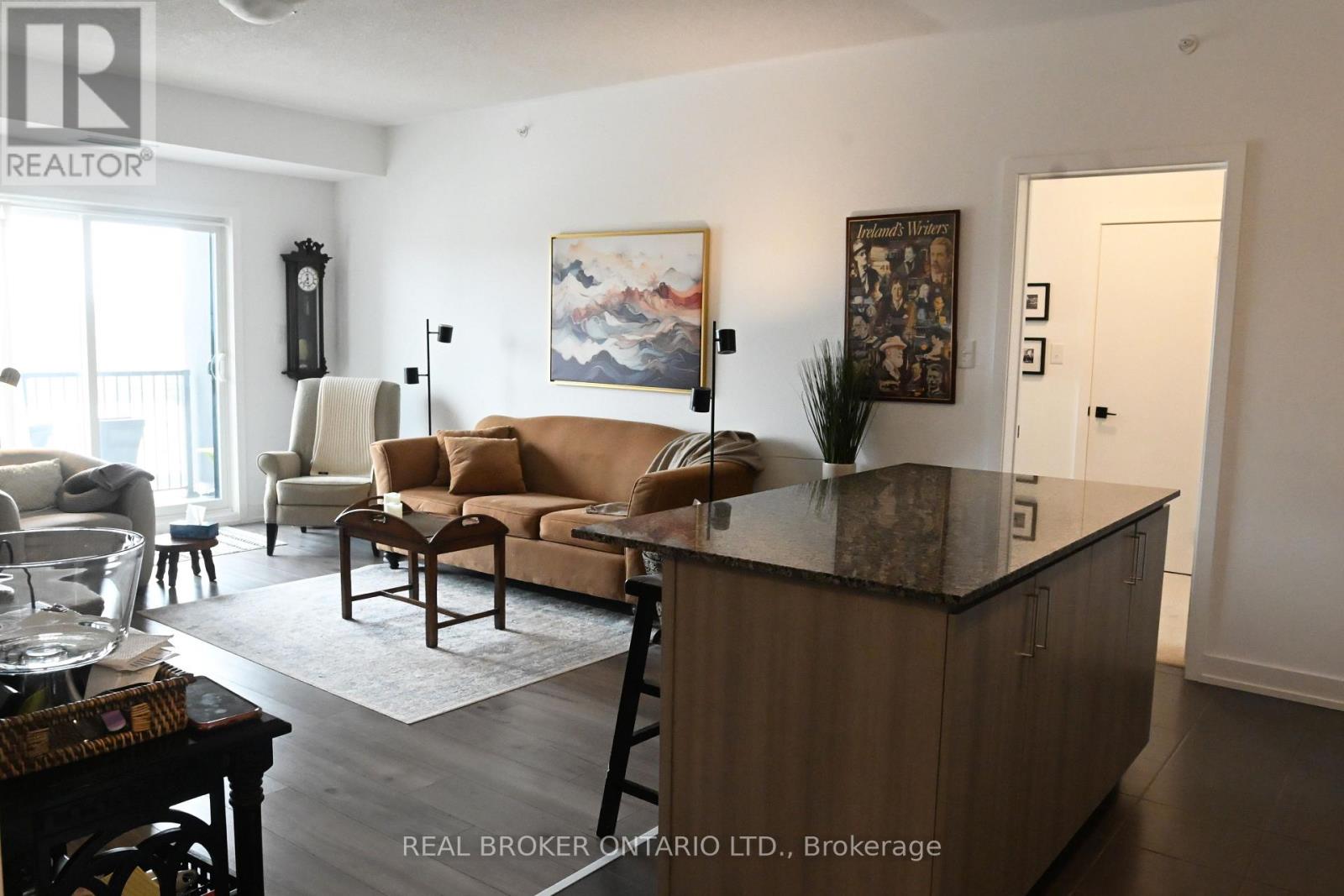 A living room with a brown couch and a wooden cabinet.