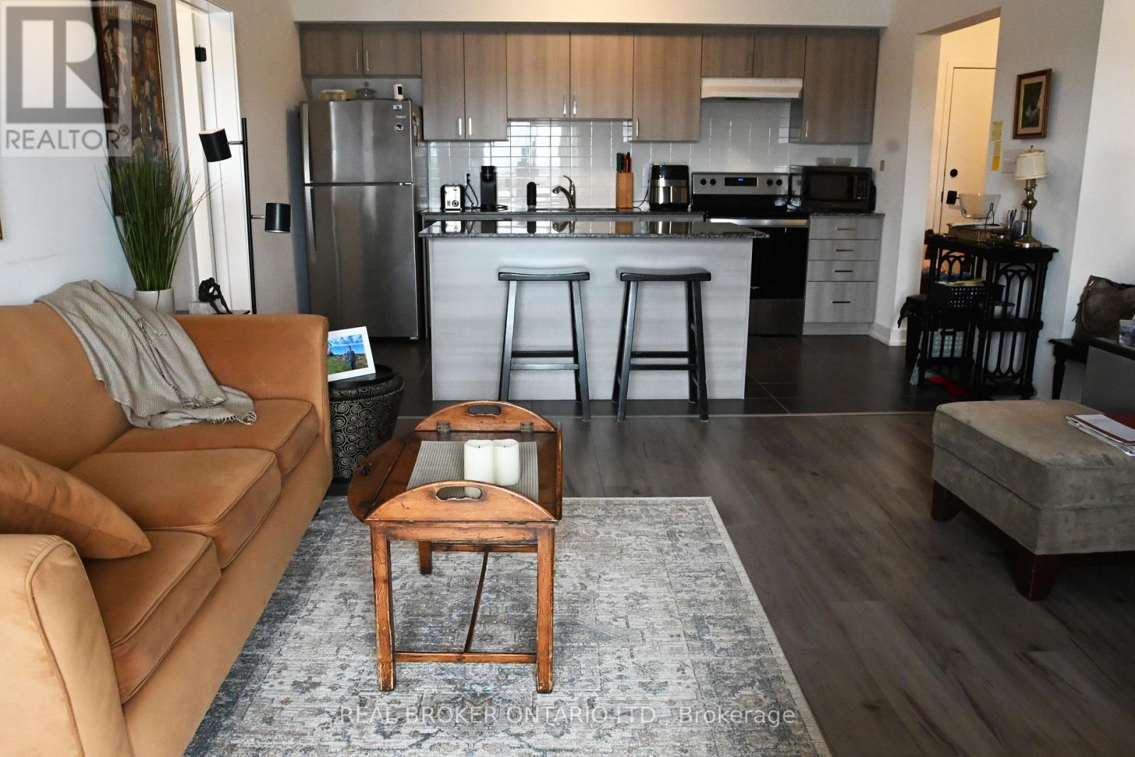 A modern kitchen with a refrigerator, stove, and oven.