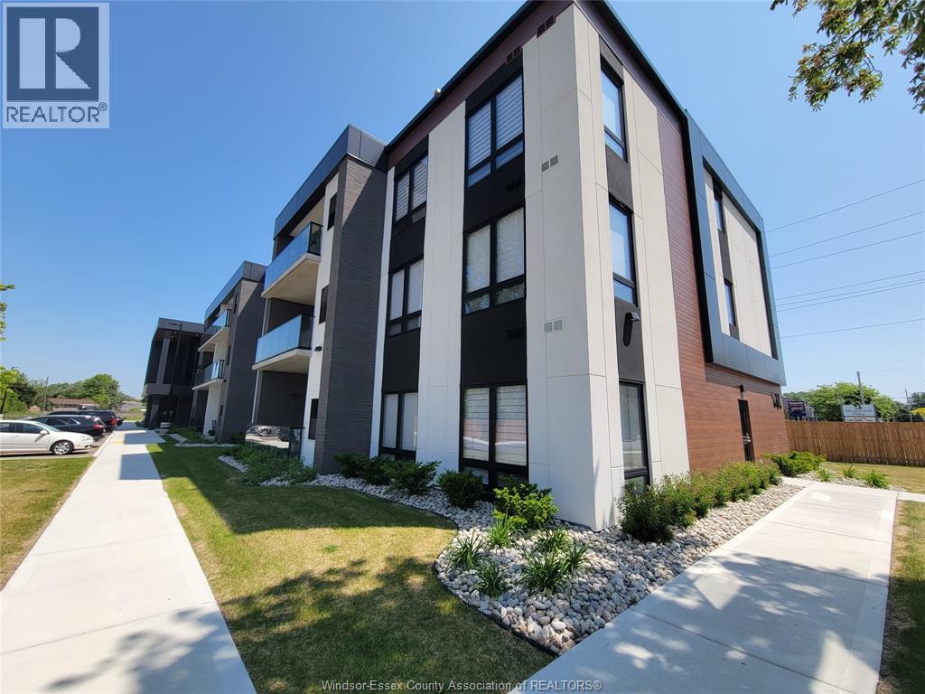 A modern apartment building with a clear blue sky above.