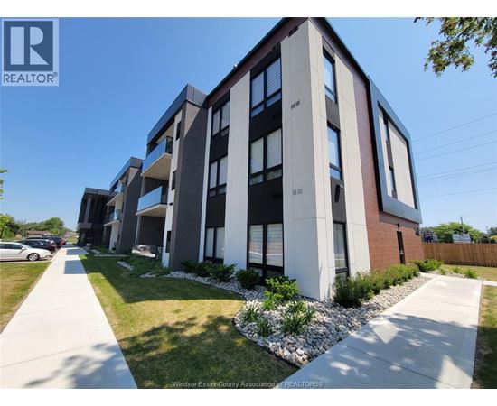 A modern apartment building with a clear blue sky above.