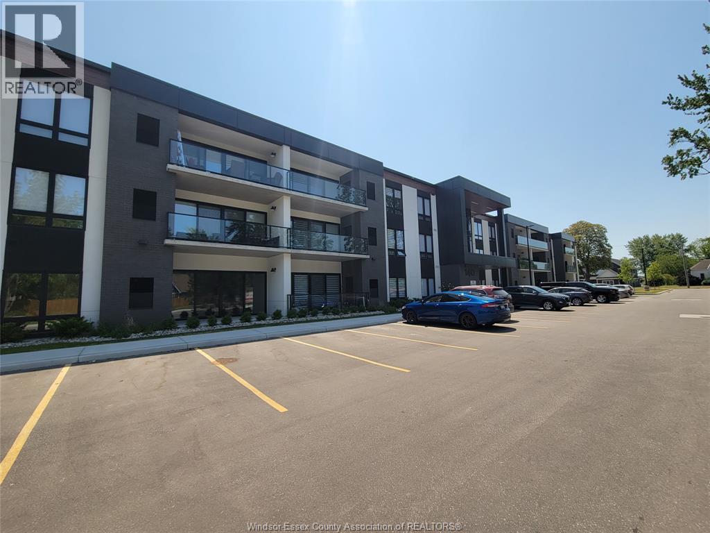 A parking lot in front of a multi-story apartment building.