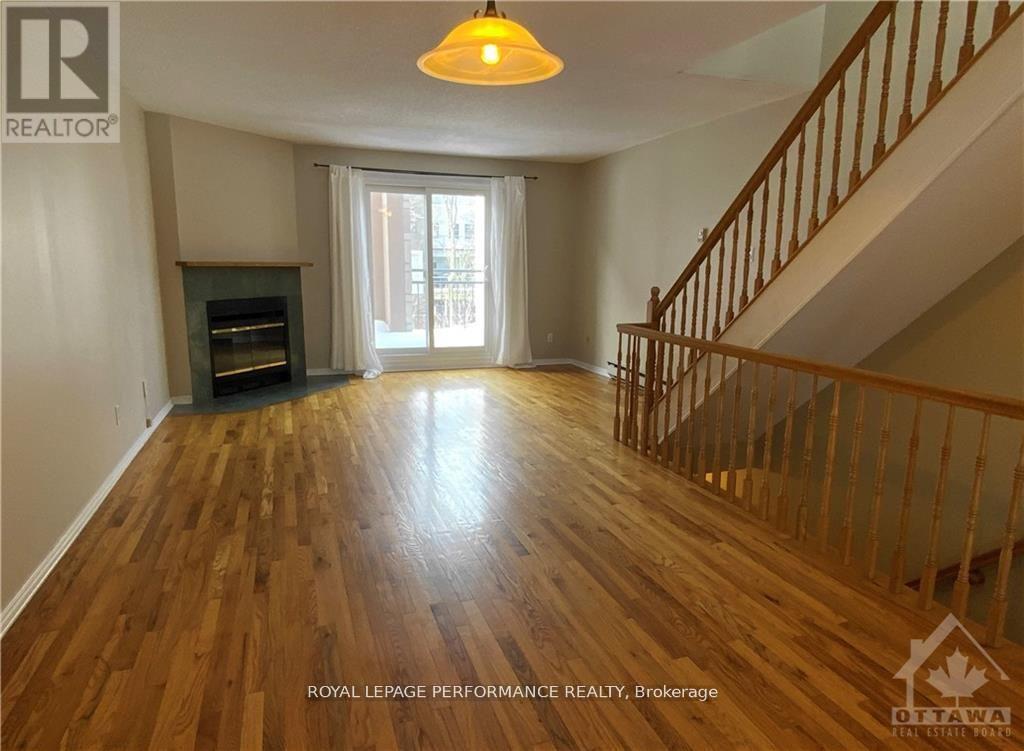 A wood floor in a house with a staircase.
