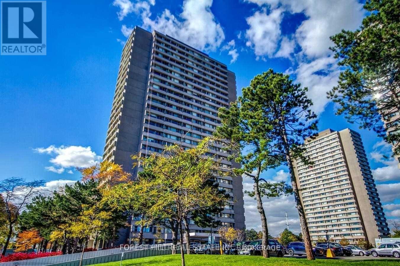 A tall building with a sign that reads REALTOR in the foreground.