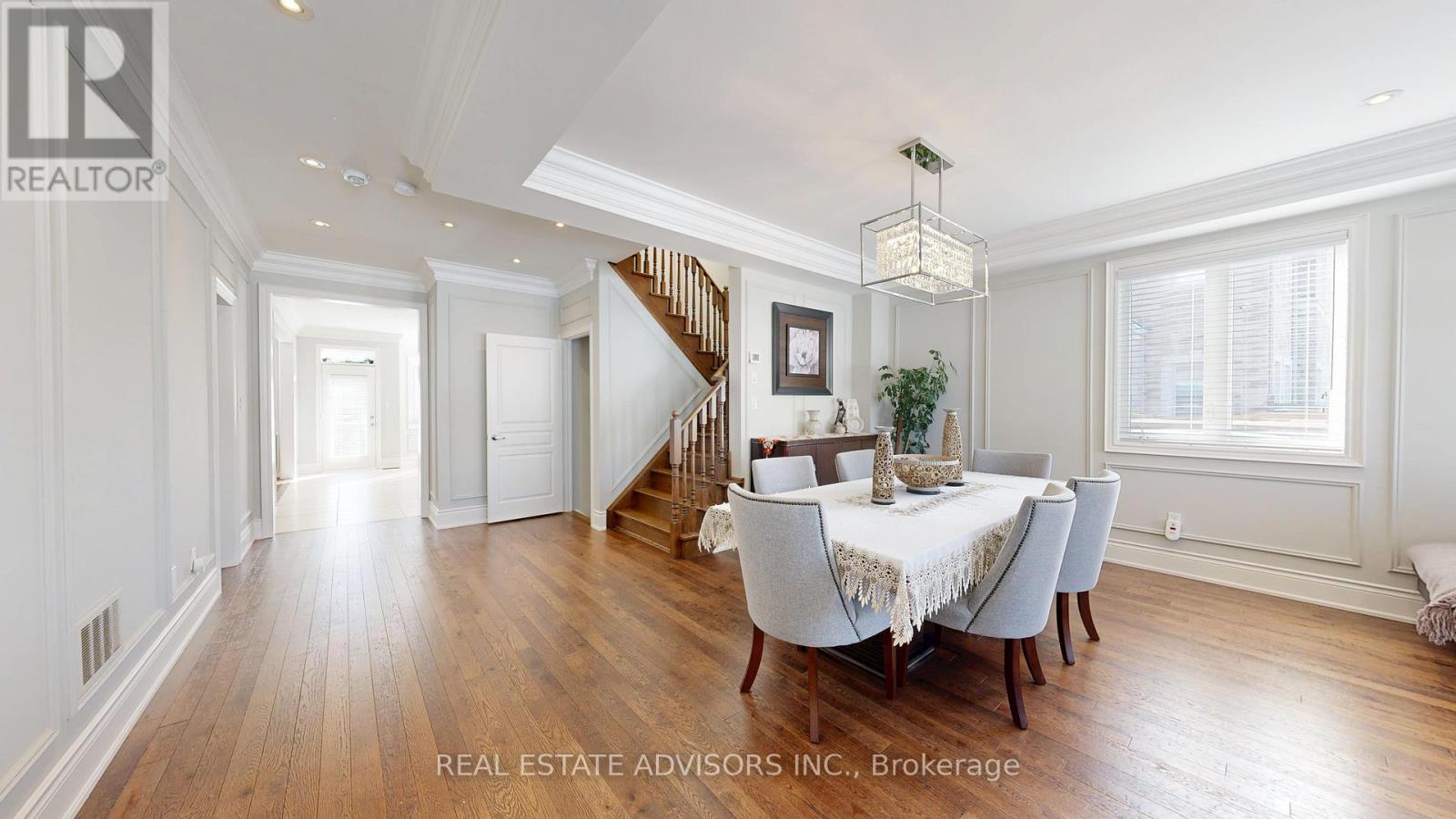A dining room with a table set for six.