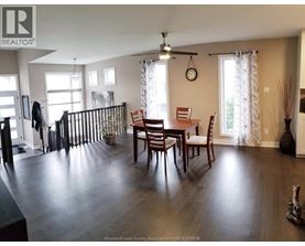 A dining room with a wooden table and chairs.