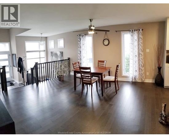 A dining room with a wooden table and chairs.