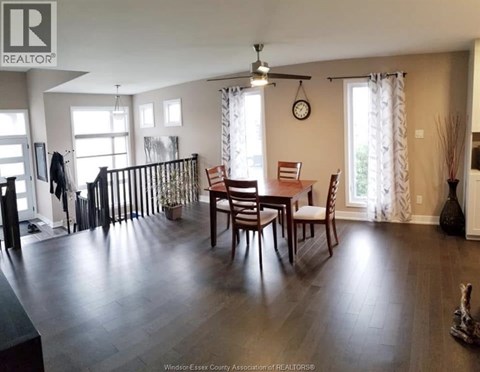 A dining room with a wooden table and chairs.