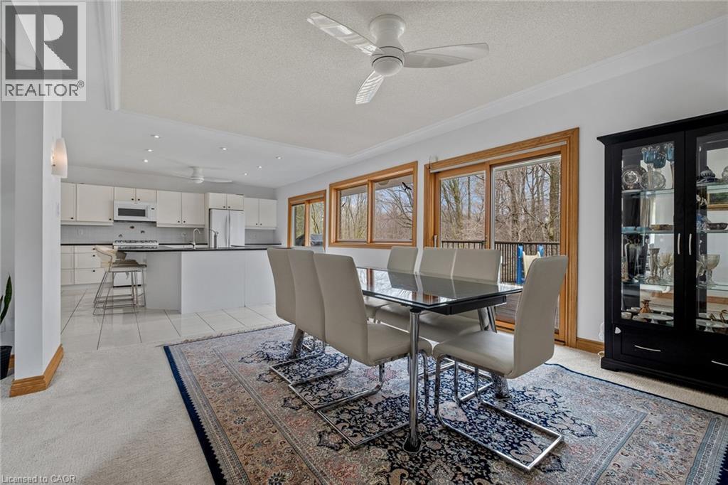 A dining room with a table and chairs.