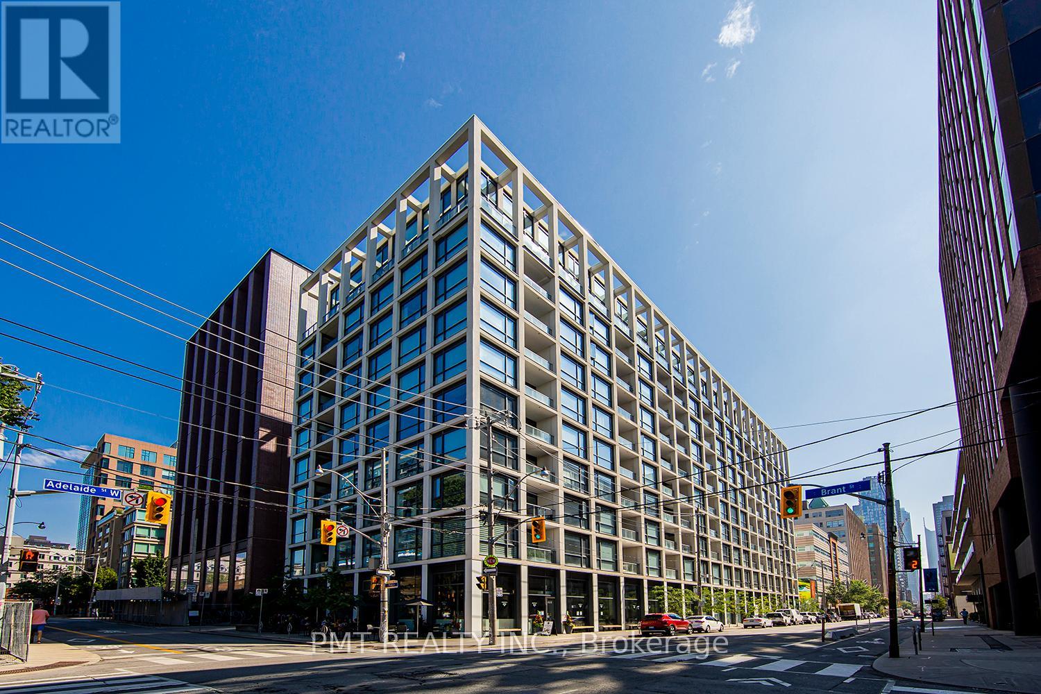 A tall building with many windows is the main focus of the image.