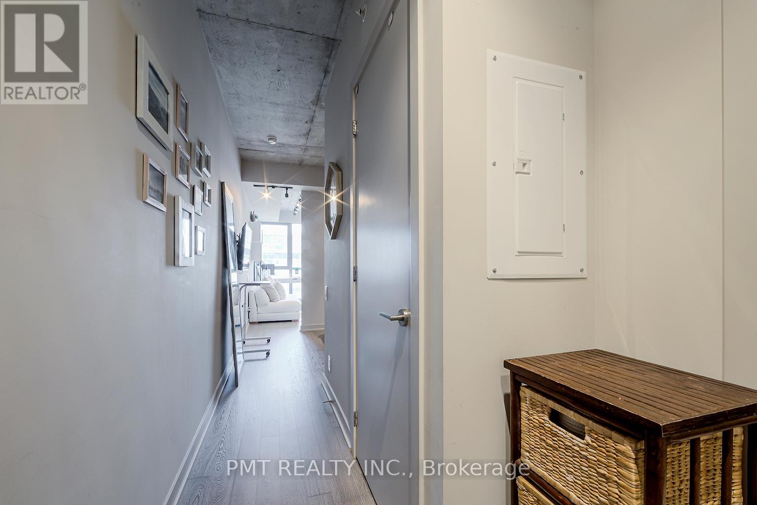 A hallway with a wooden table and a white door.