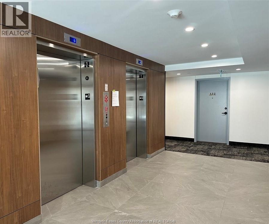 A hallway with elevators numbered 12, 13, and 14.