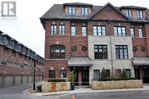 A large brick building with a stone wall in front of it.