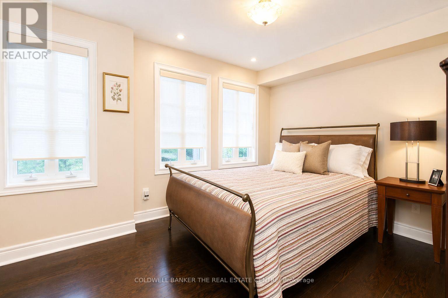 A bedroom with a large bed and a window.