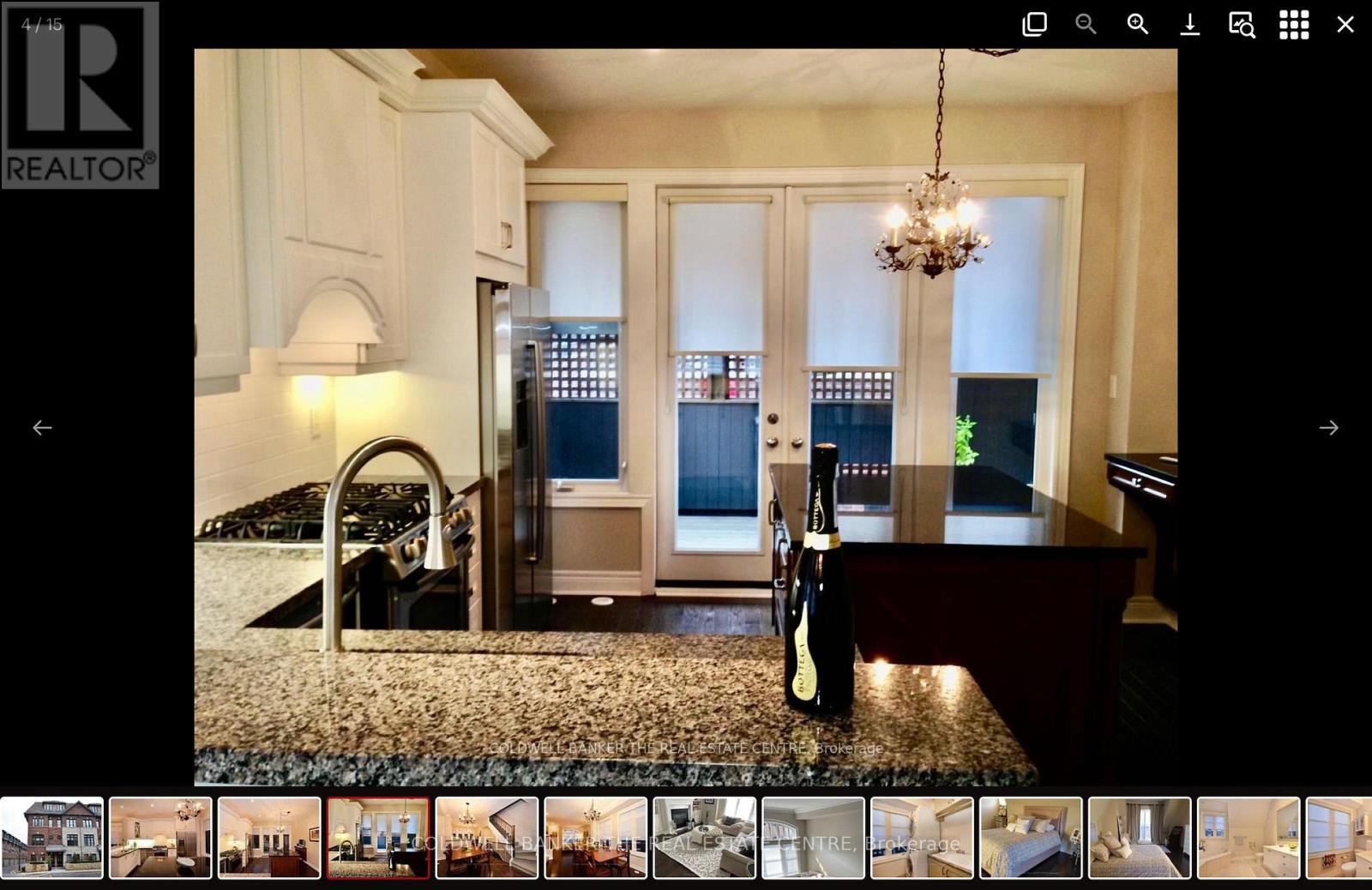 A realtor website showcasing a luxurious kitchen with a wine bottle on the counter.
