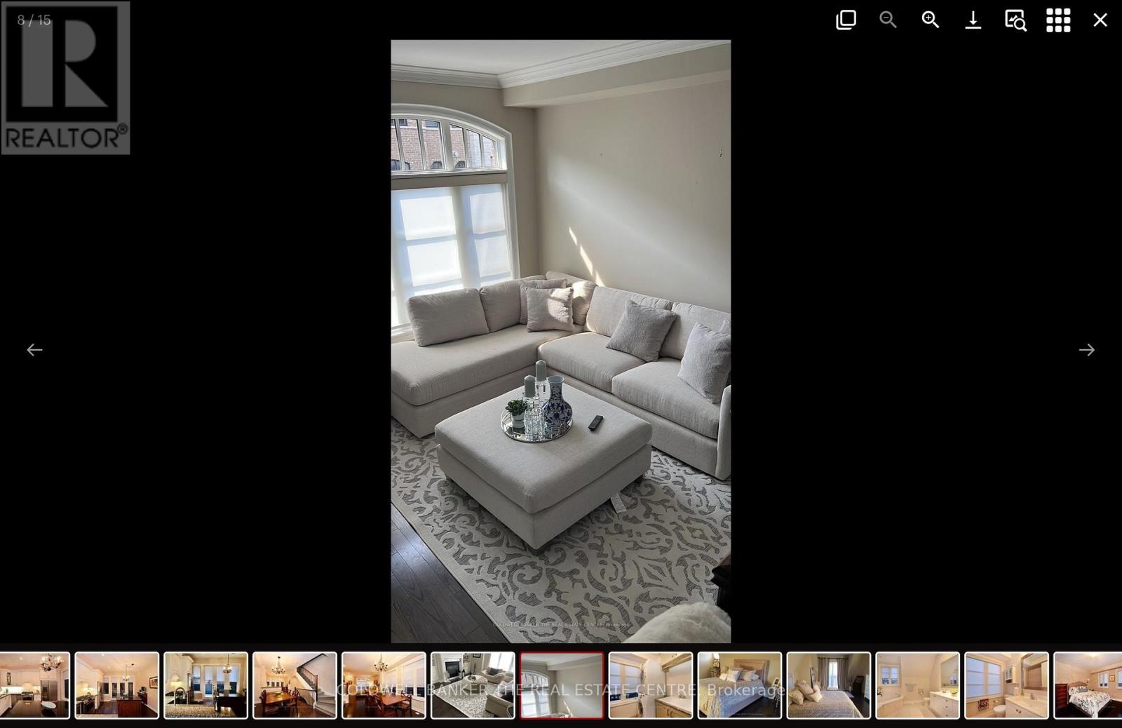 A living room with a grey sofa and a coffee table.