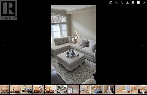 A living room with a grey sofa and a coffee table.