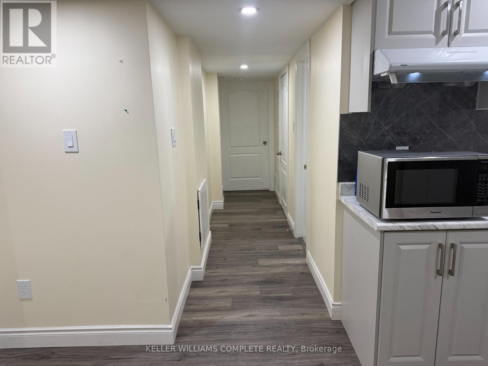 A long hallway with a kitchen area on the right.
