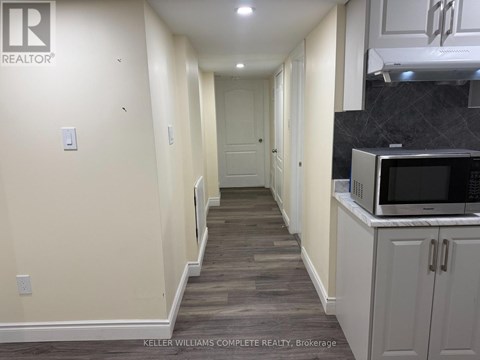 A long hallway with a kitchen area on the right.