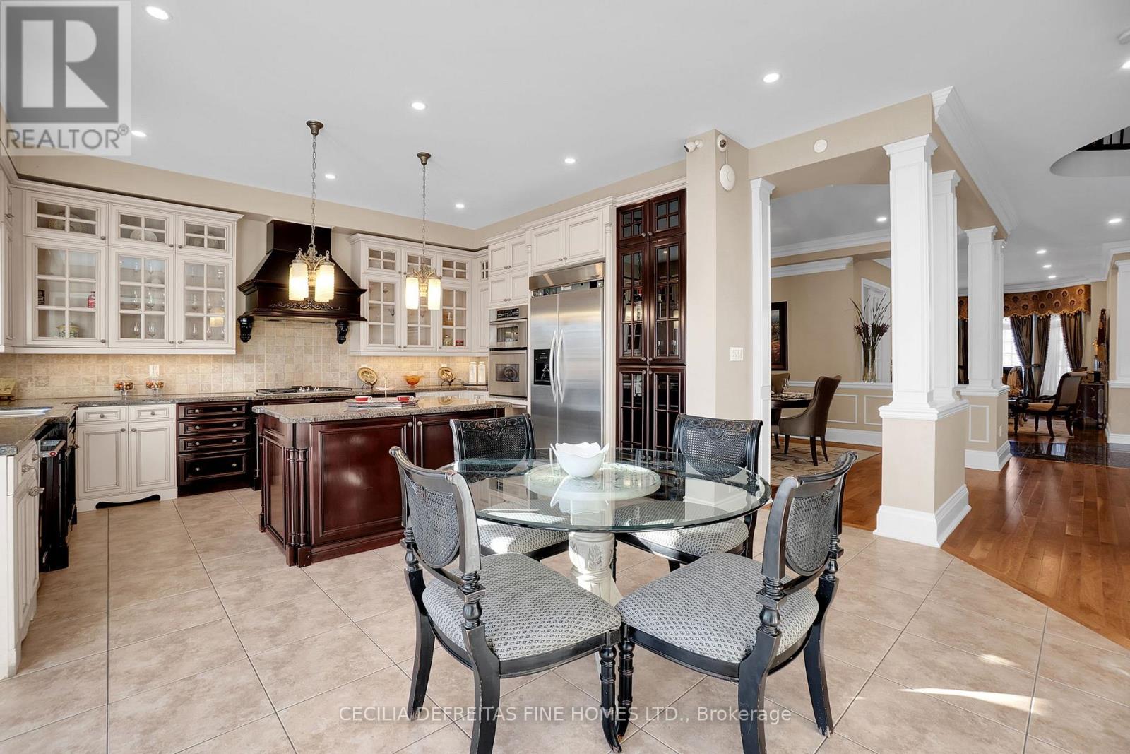 A modern kitchen with a glass table and chairs.