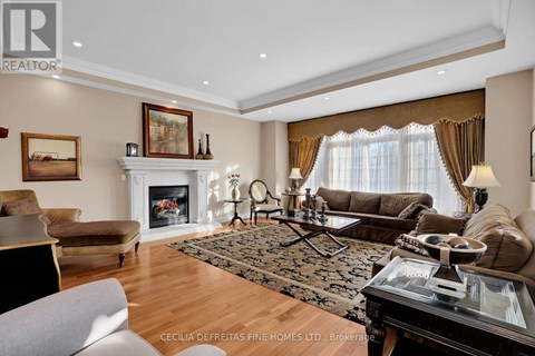 A living room with a fireplace and a painting on the wall.