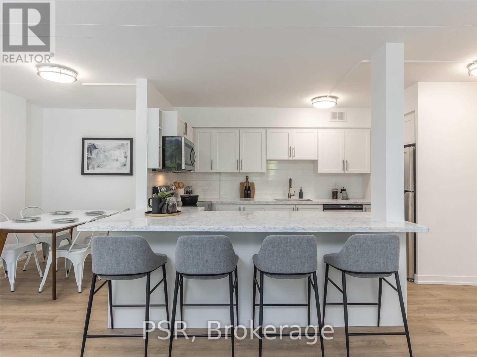 A modern kitchen with white cabinets and a central island.