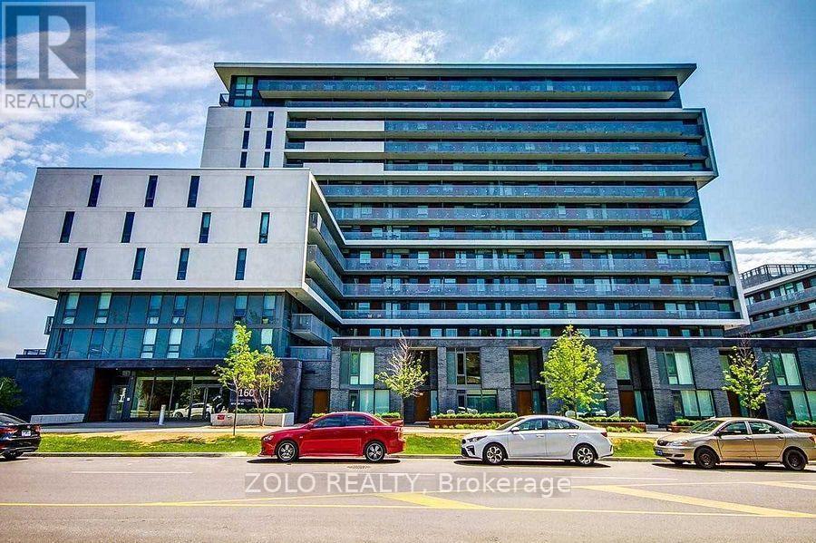 A modern building with a glass facade and a car parked in front.