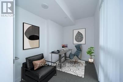 A living room with a black couch and a small table.