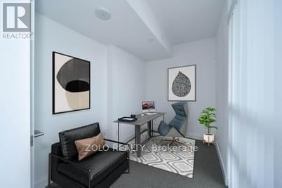 A living room with a black couch and a small table.