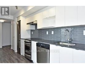 A modern kitchen with a stainless steel oven and a white countertop.