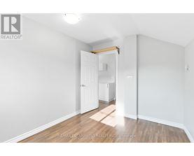 A white room with a doorway leading to another room.