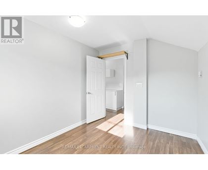 A white room with a doorway leading to another room.