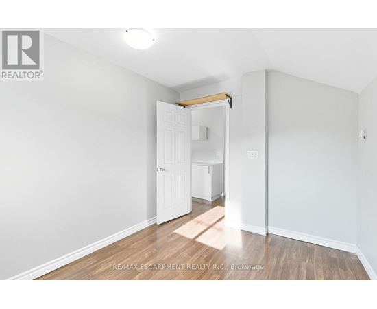 A white room with a doorway leading to another room.