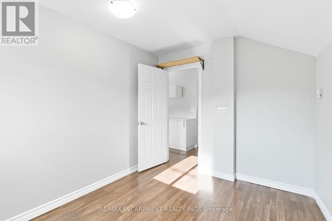 A white room with a doorway leading to another room.