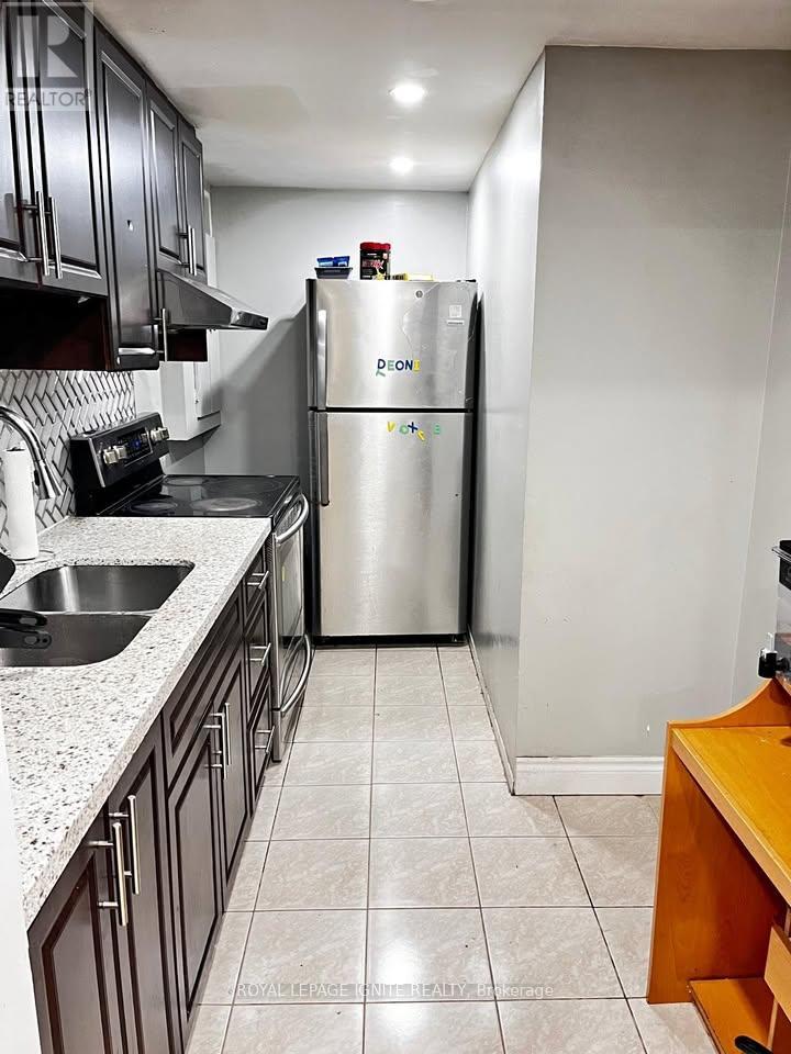 A kitchen with a stainless steel refrigerator and a counter top.