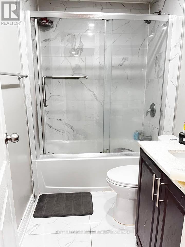 A white toilet in a marble bathroom.