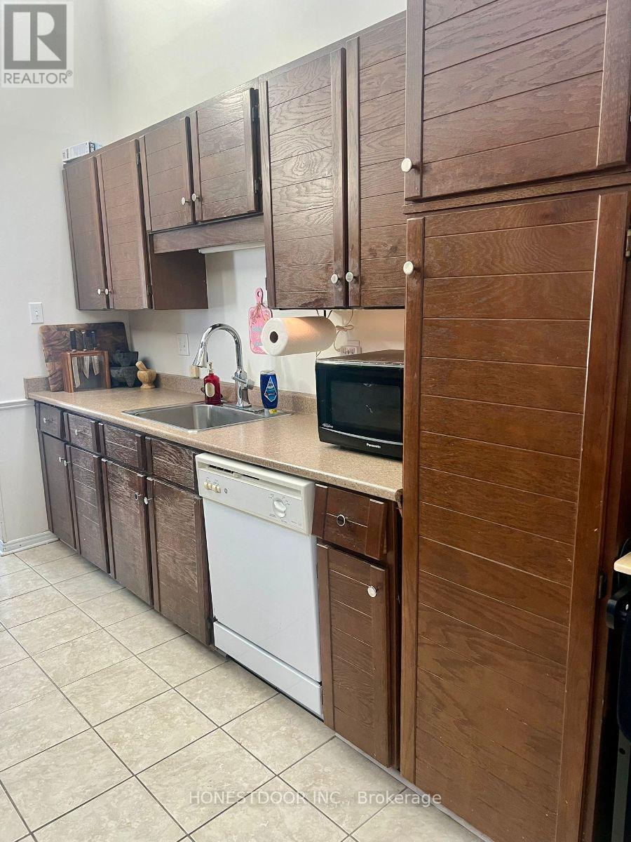 A kitchen with wooden cabinets and white appliances.
