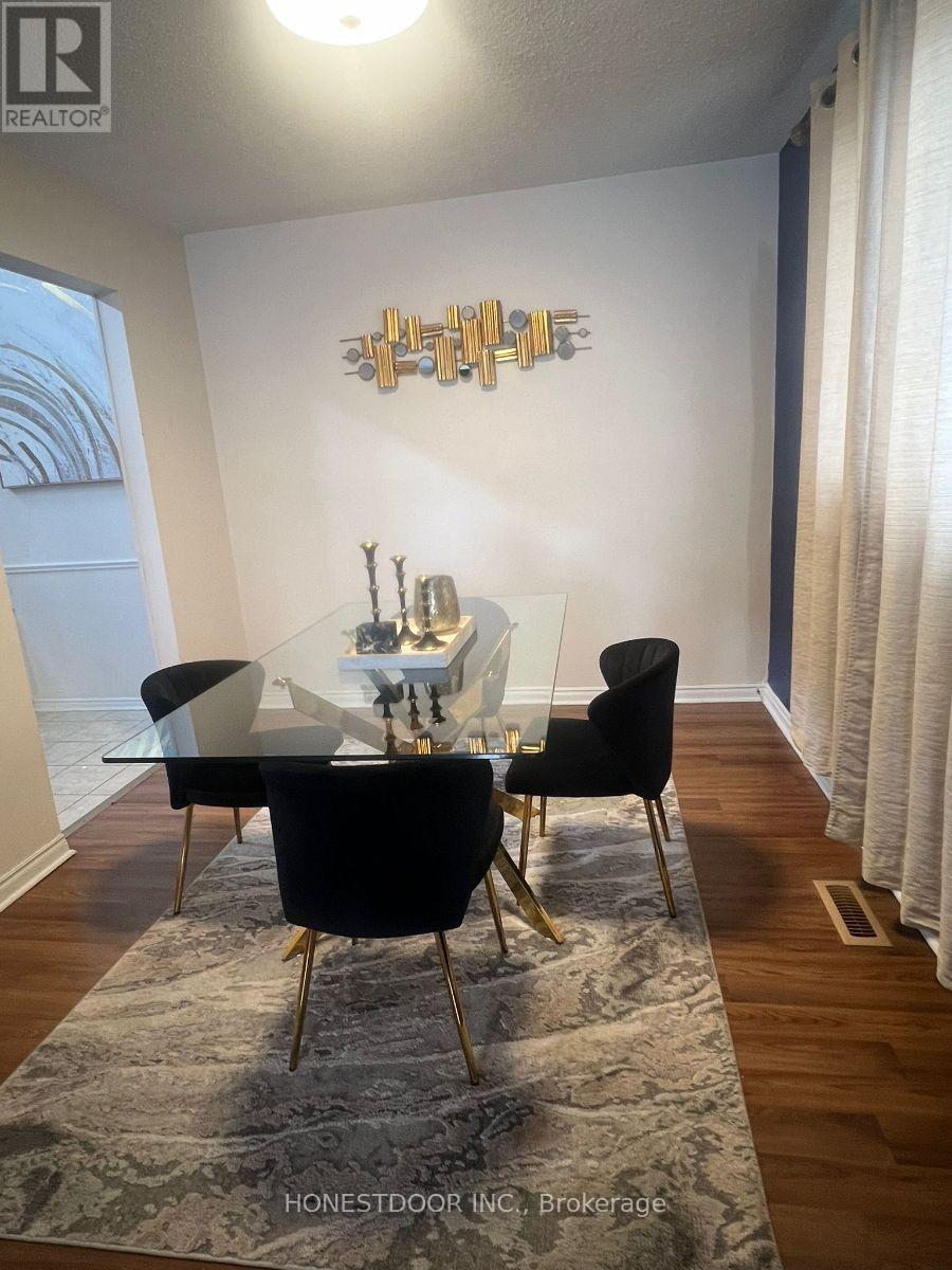 A dining room with a glass table and chairs.