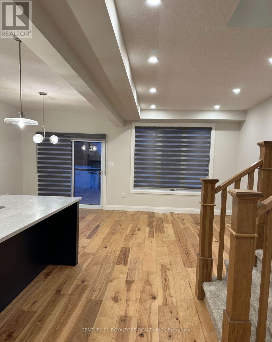 A room with wooden floors and a staircase.