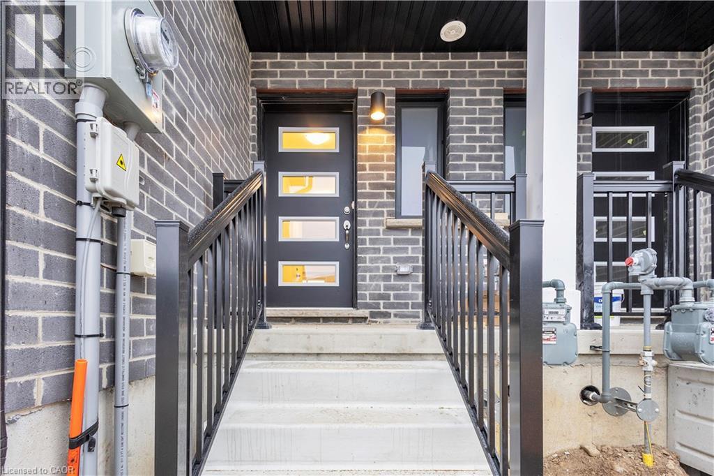 A black door with a glass window is the main focus of the image.