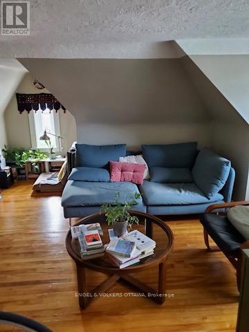 A living room with a blue couch and a wooden coffee table.