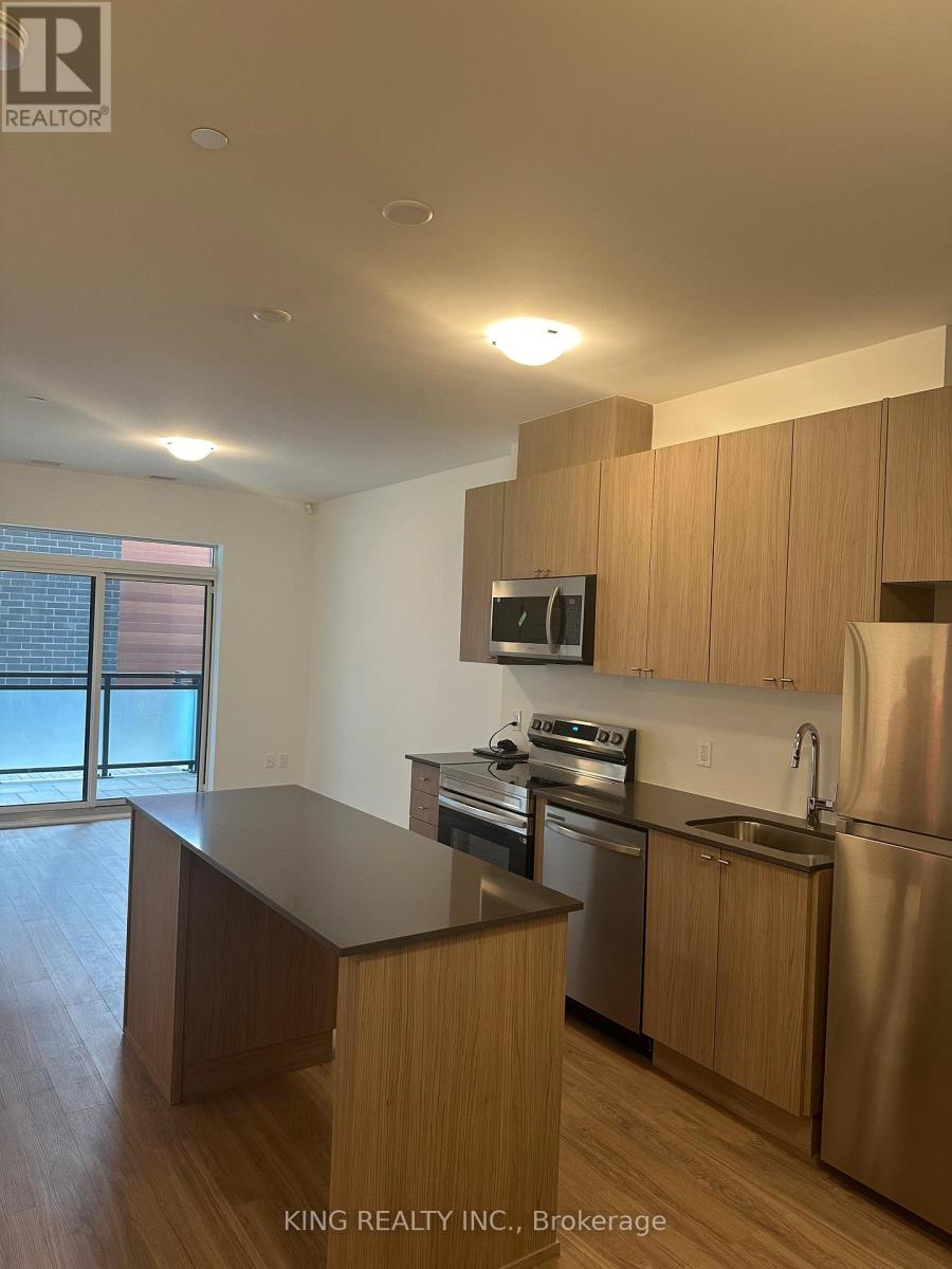 A kitchen with wooden cabinets and stainless steel appliances.