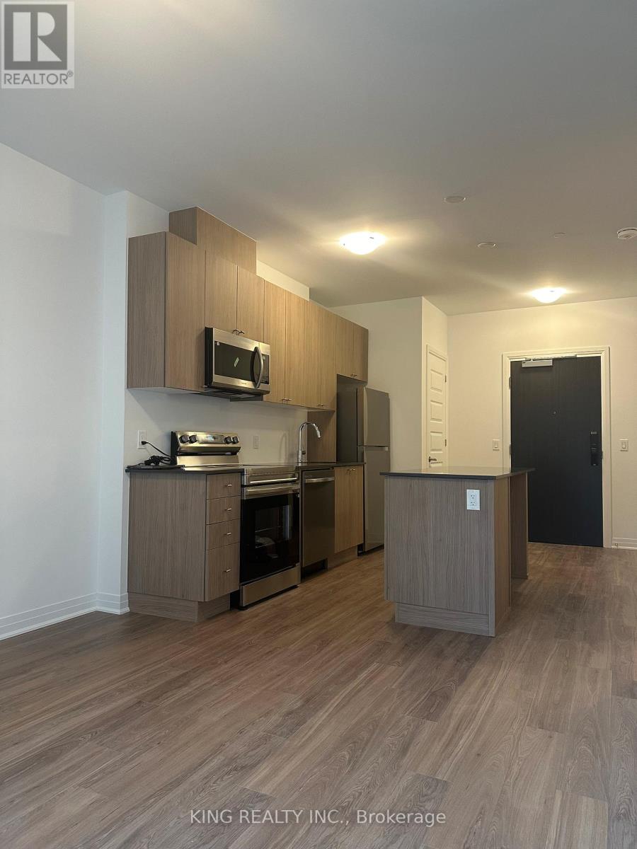 A kitchen with wooden cabinets and a microwave above the stove.