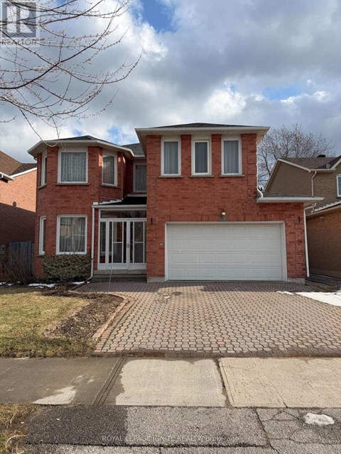 A red brick house with a white garage door.