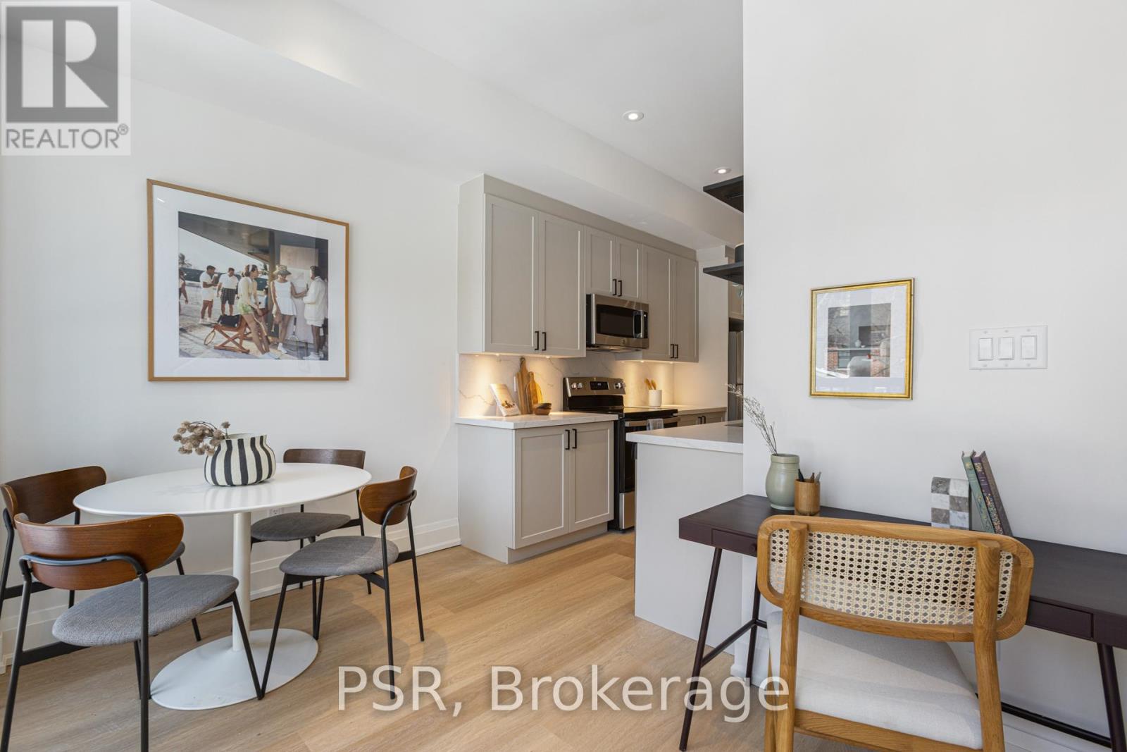 A modern kitchen with a dining table set for four.