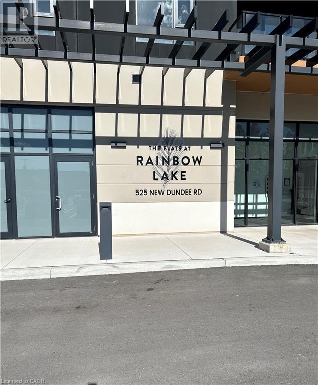The front of a building with a glass door and a sign that says "The Flats at Rainbow Lake".