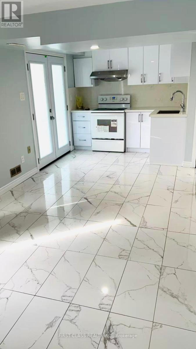 A room with marble flooring and a window with curtains.