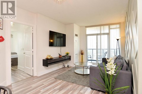 A living room with a grey sofa and a glass coffee table.