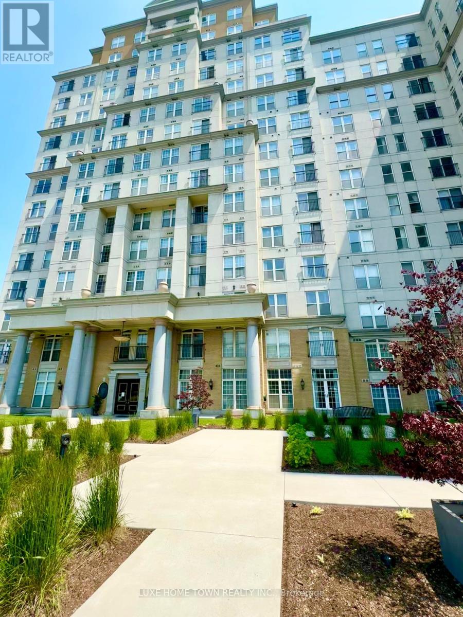 A tall building with a front entrance and a walkway leading to it.