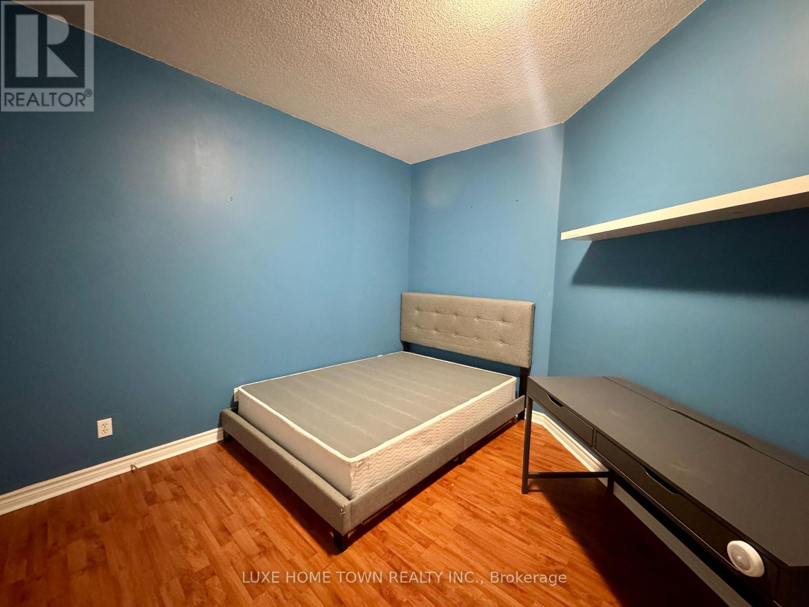 A bedroom with a bed and a bench.